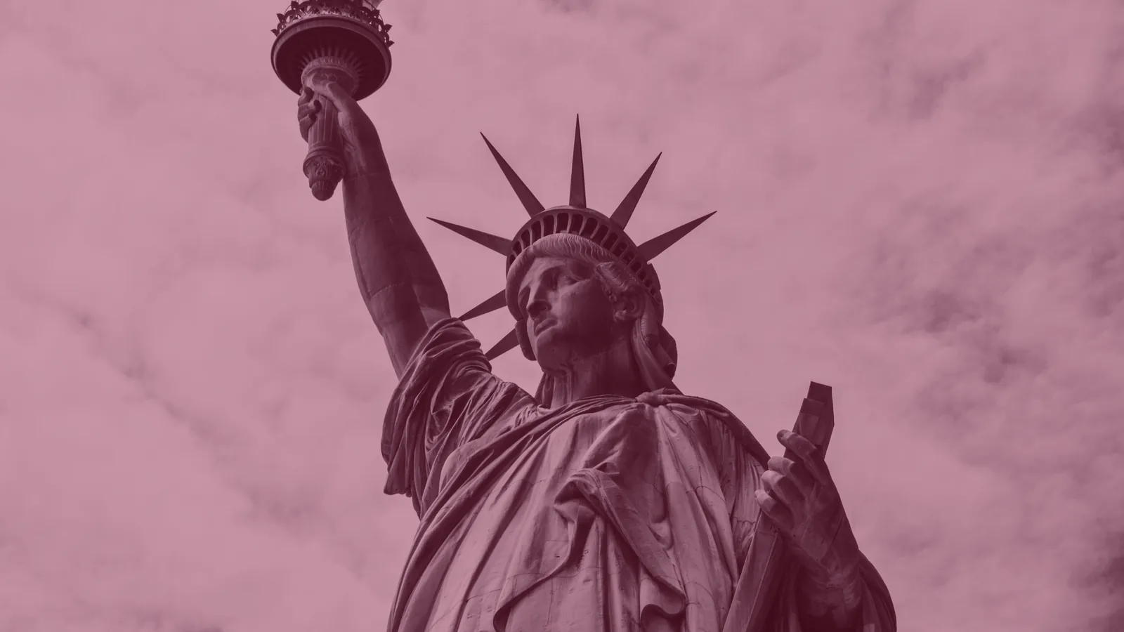 Red-tinted photo of the Statue of Liberty.