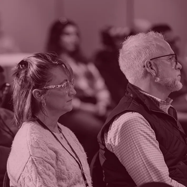 Workshop attendees seated in rows listening to a Retirement Red Flags presentation.