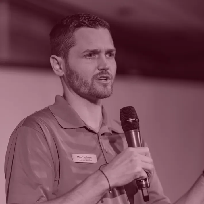 A Retirement Red Flags presenter speaks into a microphone during a workshop.